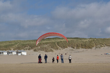 Paragliding at the beach of Katwijk aan Zee. Paraglider's making use of updraft of the dunes to stay in the air 