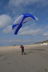 Paragliding at the beach of Katwijk aan Zee. Paraglider's making use of updraft of the dunes to stay in the air 