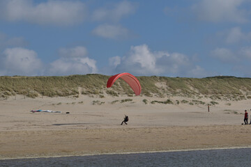 Paragliding at the beach of Katwijk aan Zee. Paraglider's making use of updraft of the dunes to stay in the air 