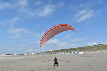 Paragliding at the beach of Katwijk aan Zee. Paraglider's making use of updraft of the dunes to stay in the air 