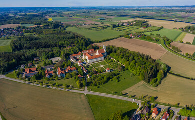 Aerial view of the  monastery Holzen in Germany, Bavaria on a sunny spring day during the coronavirus lockdown.
