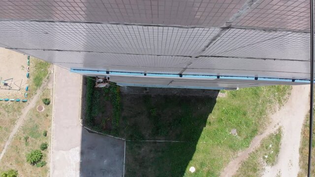 Aerial view Industrial Climber Perform Work on Insulation Side Facade Building