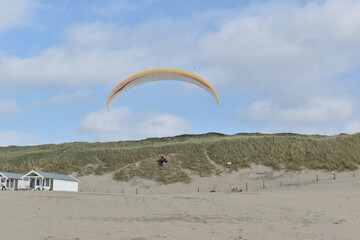 Paragliding at the beach of Katwijk aan Zee. Paraglider's making use of updraft of the dunes to stay in the air 
