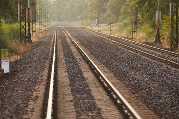 Fototapeta na wymiar Train line rails railway track with sunlight flare