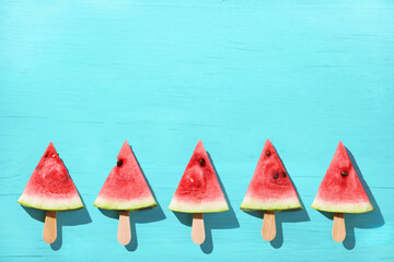 Watermelon slice popsicles on a blue color background