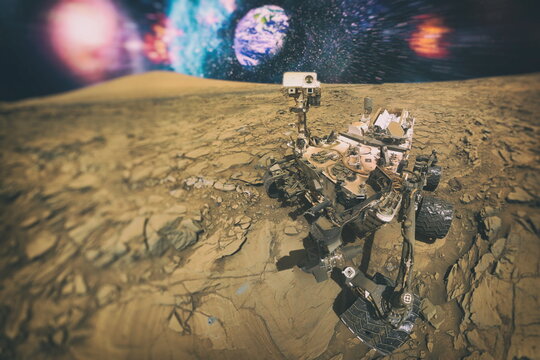 Mars Science Laboratory , Mars Exploration Rover . Mars rover on Mars and in the background the earth - Powered by Adobe