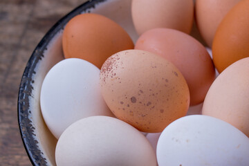different colored eggs on an old tray - closeup