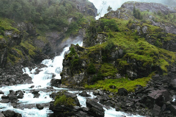 Naklejka na ściany i meble Close view green mountain waterfall