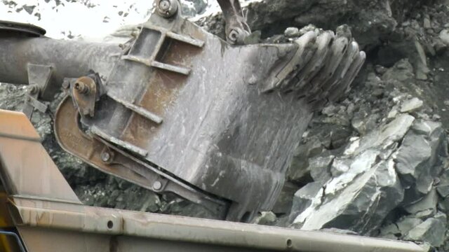 Close up view of truck excavating minerals.