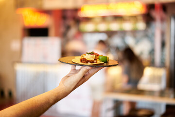 mexican food plate being hold by a hand