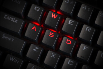 WASD keys light up in red on cool RGB mechanical gaming keyboard. WASD keys are used in many video games. © Amanda