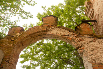 Antique brick arch with patterns over the entrance closeup. Old red brick masonry. Made at the...