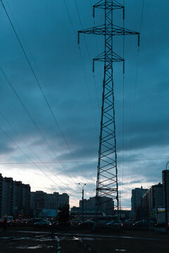 Power lines in a big city in the evening