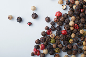 A mixture of peppers. Black, white, red polka dots. Isolated on a white background. The selected sharpness