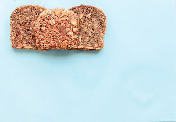 Sliced whole grain bread rye with seeds flax, sunflower, pumpkin and sesame.Healthy food, eco-friendly natural products. Fresh bread on a pink background.