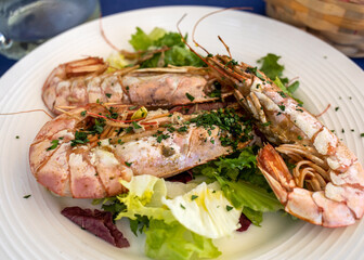 fried big shrimps with lettuce on white plate