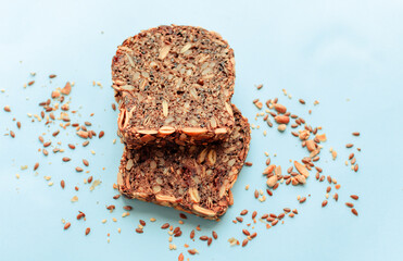 Sliced whole grain bread rye with seeds flax, sunflower, pumpkin and sesame.Healthy food, eco-friendly natural products. Fresh bread on a pink background.