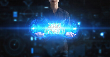 Business, Technology, Internet and network concept. Young businessman working on a virtual screen of the future and sees the inscription: 2021 goals