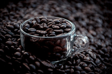 Cup made out of glass filled with coffee beans