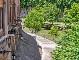 Rome Italy, picturesque balconies and colorful flowers with a view  to Tiber river
