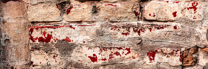 Texture of a brick wall with cracks and scratches which can be used as a background