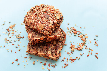 Sliced whole grain bread rye with seeds flax, sunflower, pumpkin and sesame.Healthy food, eco-friendly natural products. Fresh bread on a pink background.