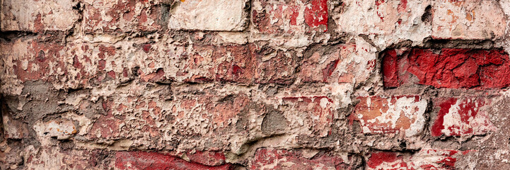 Texture of a brick wall with cracks and scratches which can be used as a background