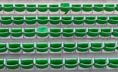 green plastic chairs folded forming a row of seats