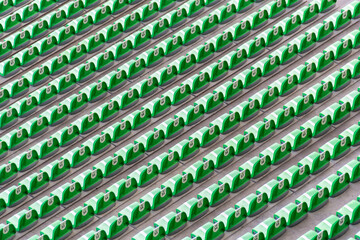 pattern of diagonal rows of green plastic seats with white labes