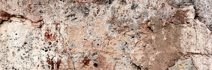 Texture of a concrete wall with cracks and scratches which can be used as a background