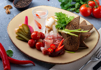 Cold vodka with pepper, pickled vegetables and brown bread