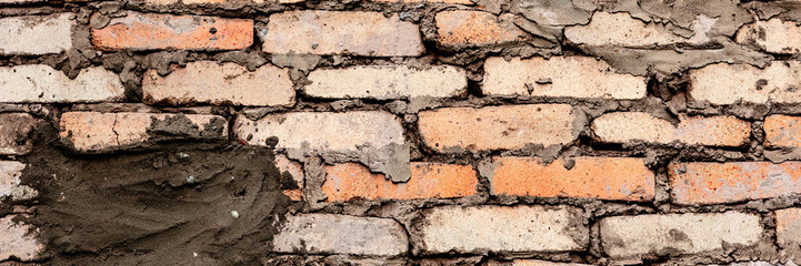 Texture of a brick wall with cracks and scratches which can be used as a background