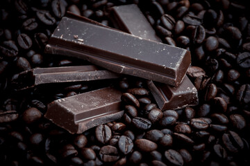 sweet and tasty dark chocolate bars surrounded by coffee beans