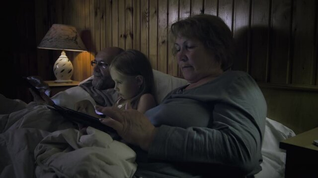 Grandparents with child lying in bed