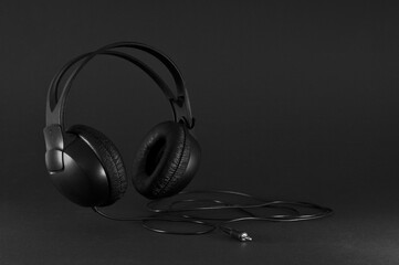 Fototapeta na wymiar Black headphones on a black background