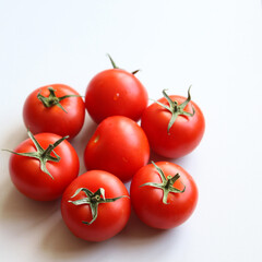 ripe tomatoes on a white background close up