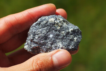 Hematite Iron Oxide shiny metallic rock from China held in a hand