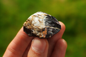 Magnetite rock mineral from China held in a hand