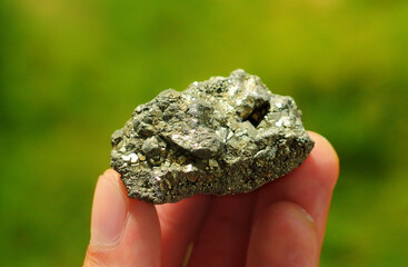 Pyrite or Fool's Gold from Perú held in a hand