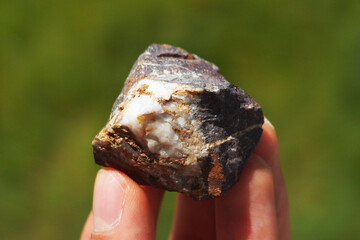 Magnetite rock mineral from China held in a hand