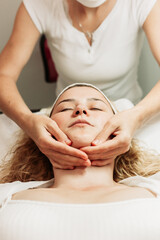 Close-up of face massage treatment. Young Caucasian woman. Beauty treatments