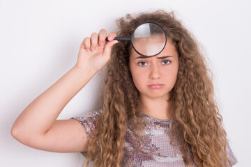 teenage skin problem, girl holding magnifier over her face