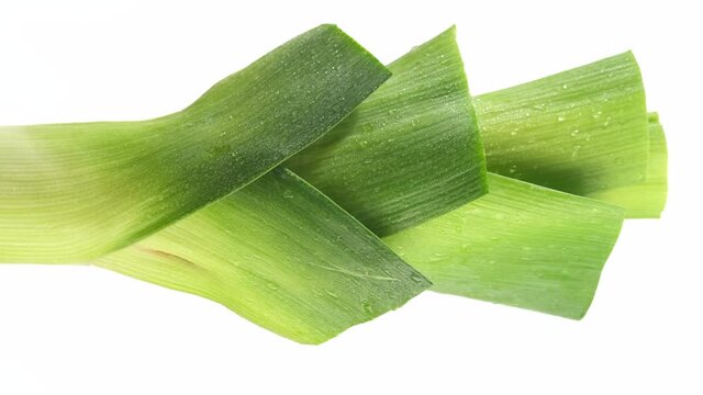 rotating fresh leek isolated on white background. vertical video