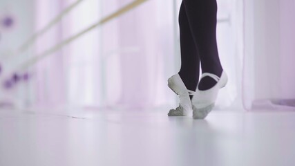 Dance of the ballerina. Female ballet dancer dancing in pointe shoes in studio. © stanis88