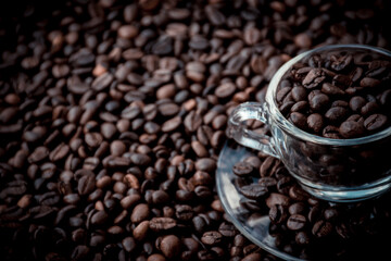 coffee beans in a cup and around the cup