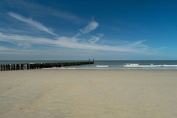 wooden groynes at the beach in Zeeland, Holland