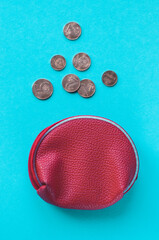 Red purse almost empty with Euro coins