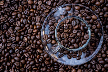 coffee beans in a cup and around the cup