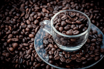 coffee beans in a cup and around the cup