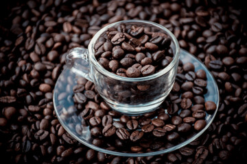 coffee beans in a cup and around the cup